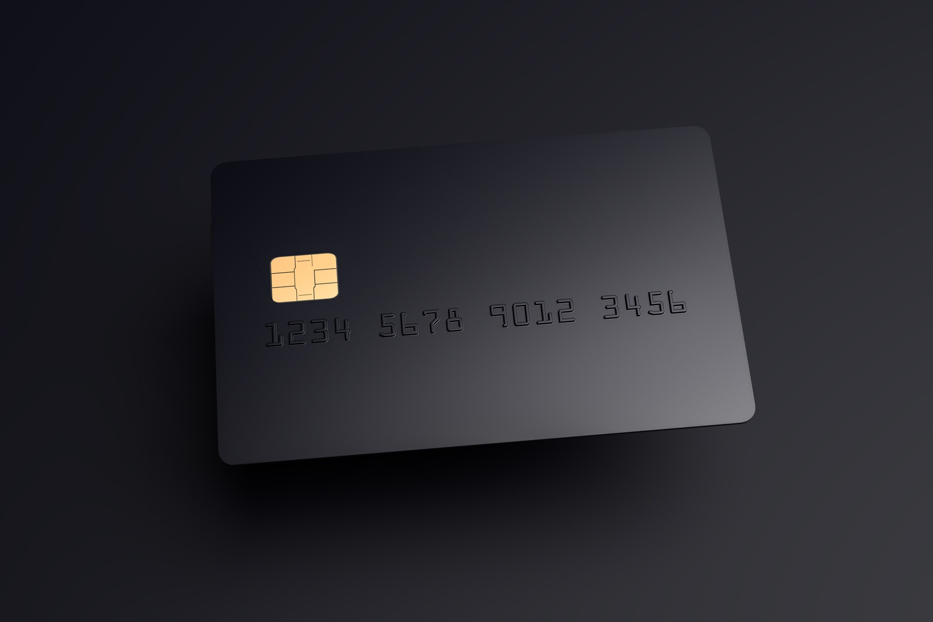 A blank black credit card hovering over a black surface with shadow